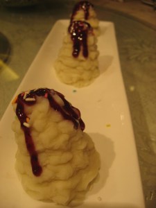 mashed yam with blueberry sauce, and sprinkles