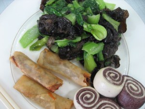a desperate lunch. veggie spring rolls, greens and mushrooms, bread